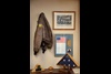 Clockwise from left: Jacket worn by Spetman’s father in World War II; photo of his father’s bomber crew; framed “chit” carried by Spetman in Gulf War, to be given to captors if he were shot down.