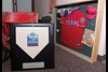 The commemorative home plate honors the first season at Target Field, home of the Twins and a Sportservice client. Next to it is a display case with Texas Rangers 2010 World Series items.