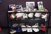 A table holds autographed hats, balls and photos.
