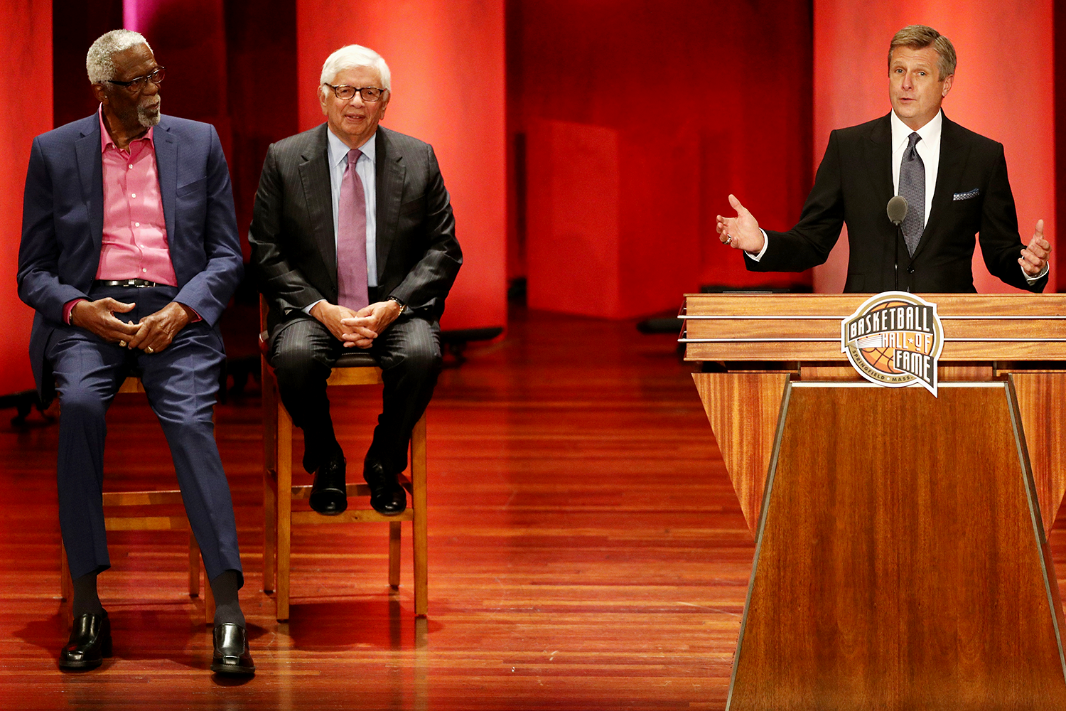 Rick Welts gives his Hall of Fame speech as Bill Russell (far l.) and David Stern look on in Sept. 2018 (Maddie Meyer/Getty Images).